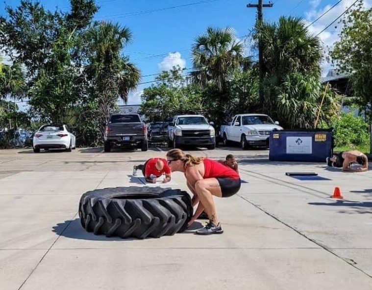 A women doing workout with tyre