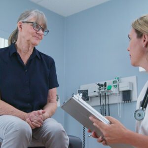 A doctor taking medical history of the older patient