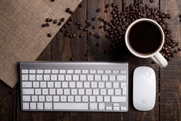 A view of the keyboard, mouse and coffee beans